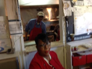 Linda McRae (front) takes orders as her father prepares food in the kitchen behind the window. (Ray Linville)
