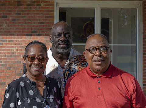 Three leaders of Kingdom Voices United stand outside New Vision of Christ Christian Center in Dunn, North Carolina.